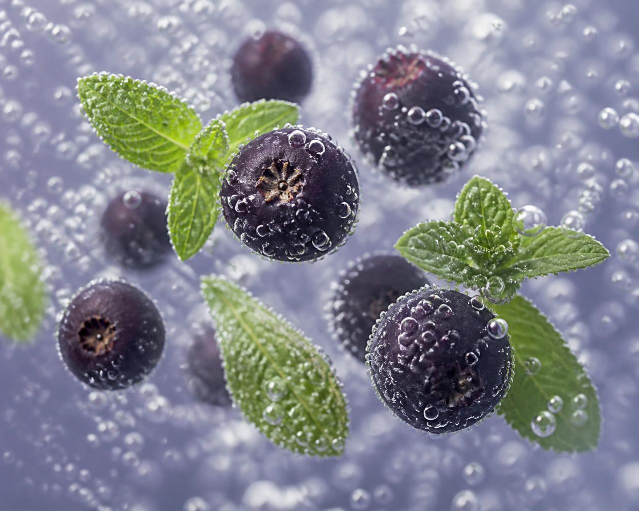 Deep violet aronia pigment blooming through clear water